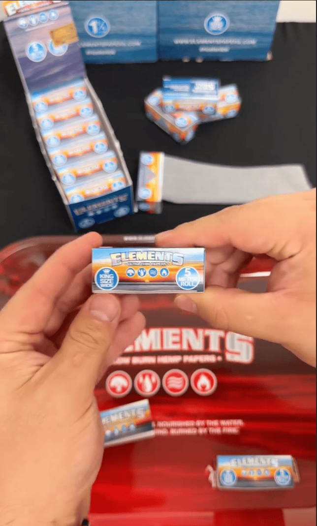 A person holding Elments Ultra thin papers